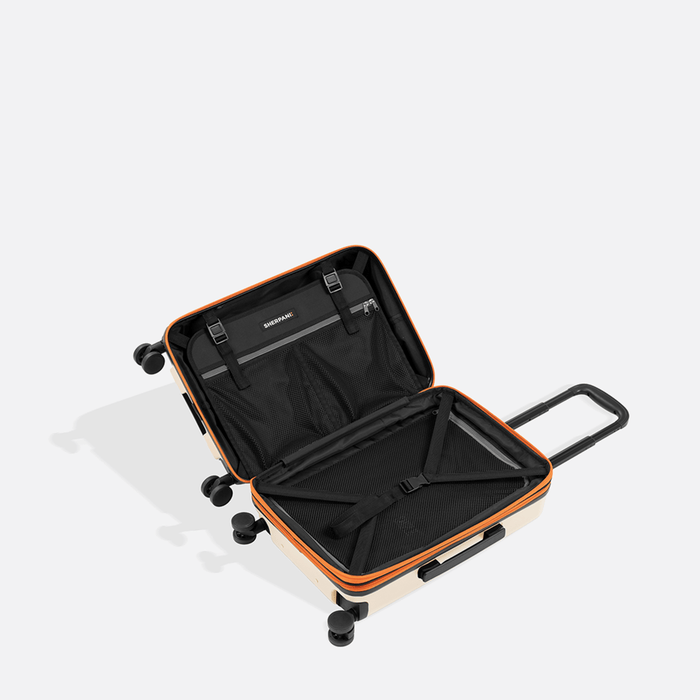 A Sherpani Meridian Chai Beige Carry-On Luggage, above view showing inside packing spaces on white backdrop.  #color_chai-beige