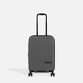 A Sherpani Meridian Granite Carry-On Luggage, front view showing handle and zipper extender on white backdrop.  #color_granite-grey