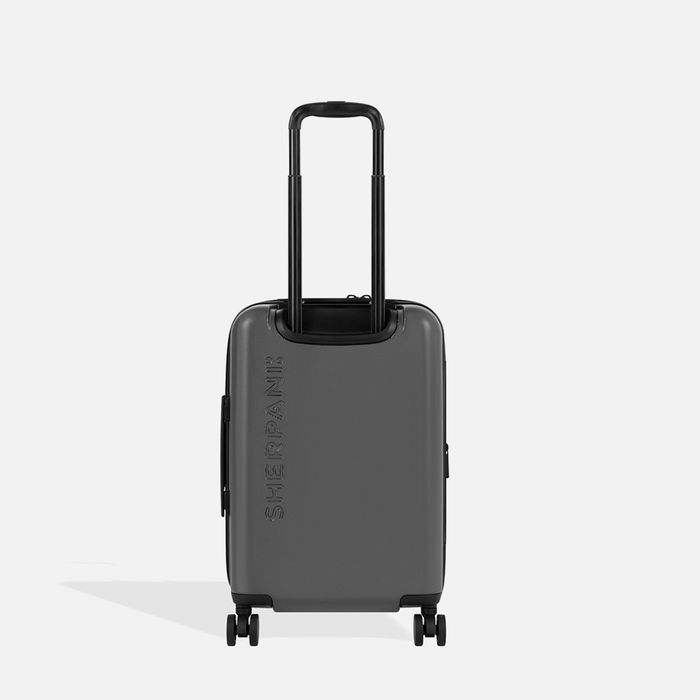 A Sherpani Meridian Granite Carry-On Luggage, back view showing handle and Sherpani logo on white backdrop.  #color_granite-grey