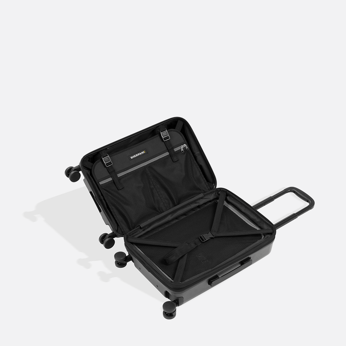 A Sherpani Meridian Granite Carry-On Luggage, above view showing inside packing spaces on white backdrop. #color_granite-grey