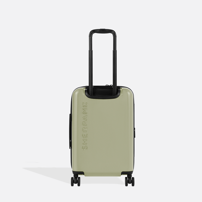 A Sherpani Meridian Matcha Carry-On Luggage, back view showing handle and Sherpani logo on white backdrop.  #color_matcha-green