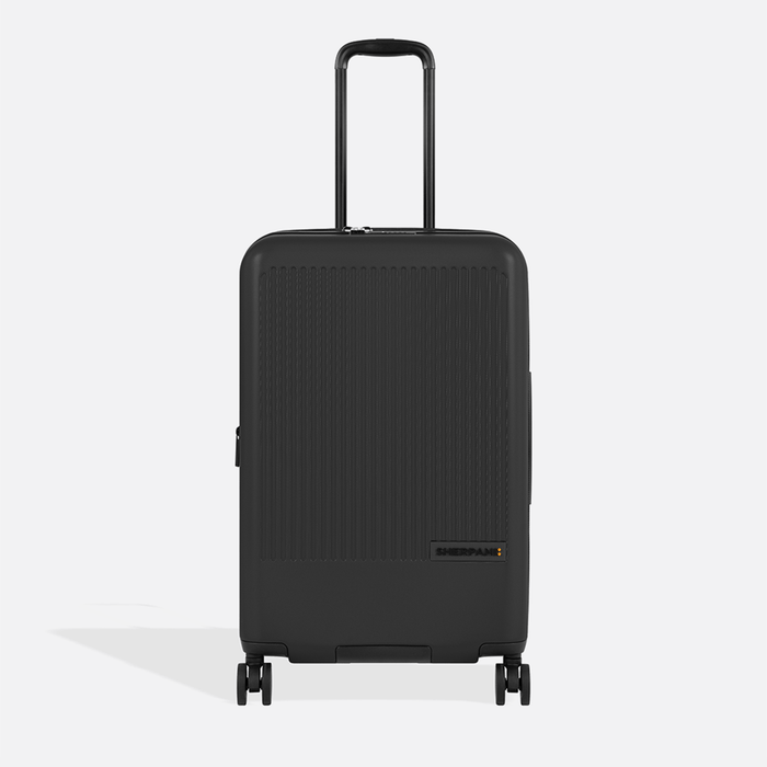 A Sherpani Meridian Black Checked-Luggage, front view showing handle and zipper extender on white backdrop.   #color_black