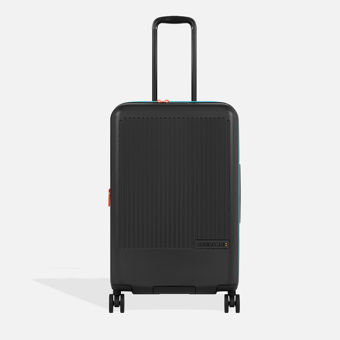 A Sherpani Meridian Chromatic Black Checked-Luggage, front view showing handle and zipper extender on white backdrop. #color_chromatic-black