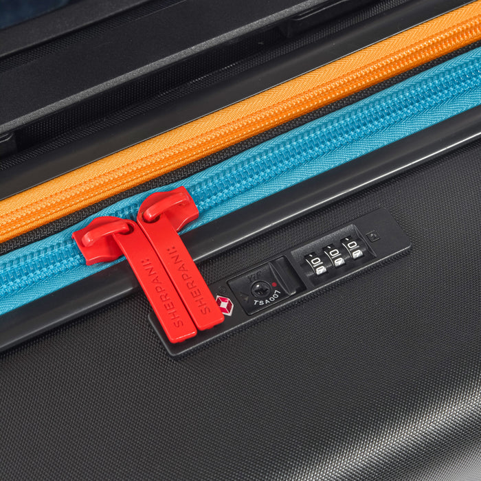 Close-up of zipper code lock on a Sherpani Meridian Chromatic Black Checked-Luggage. #color_chromatic-black