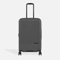 A Sherpani Meridian Granite Checked-Luggage, front view showing handle and zipper extender on white backdrop.    #color_granite-grey