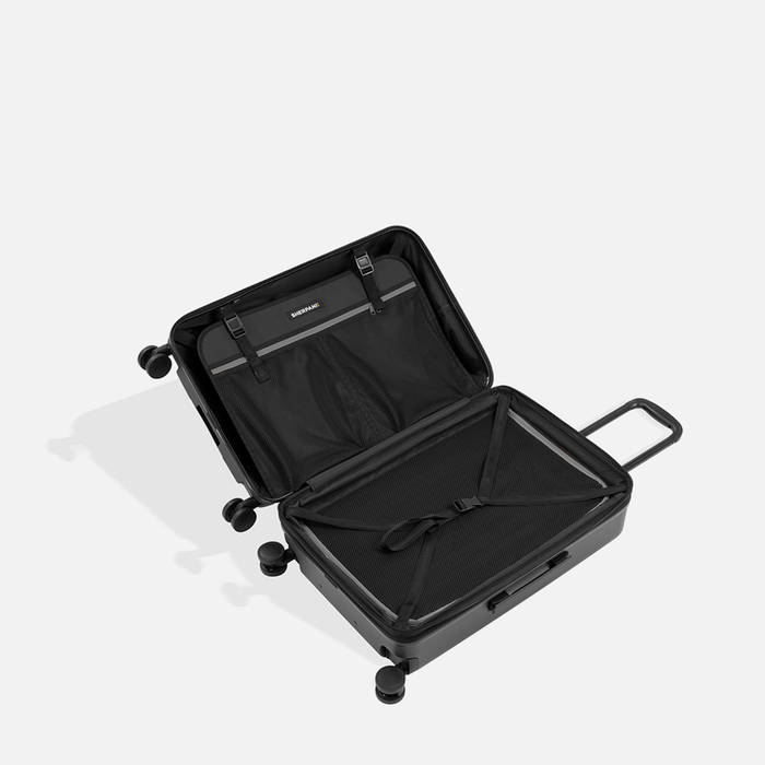 A Sherpani Meridian Granite Carry-On Luggage, above view showing inside packing spaces on white backdrop.  #color_granite-grey