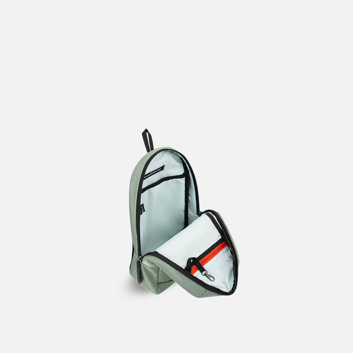 A Sherpani Metro Aloe Mist Green Anti-theft Reversible Sling, 3/4 view open showing inside pocket against white background. #color_aloe-mist-green