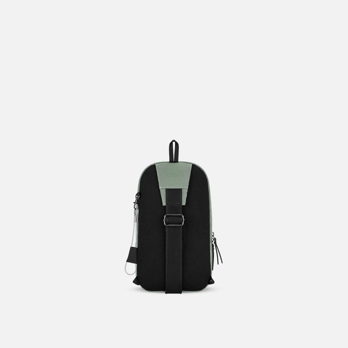 A Sherpani Metro Aloe Mist Green Anti-theft Reversible Sling, back view showing strap & chair lock on white backdrop. #color_aloe-mist-green