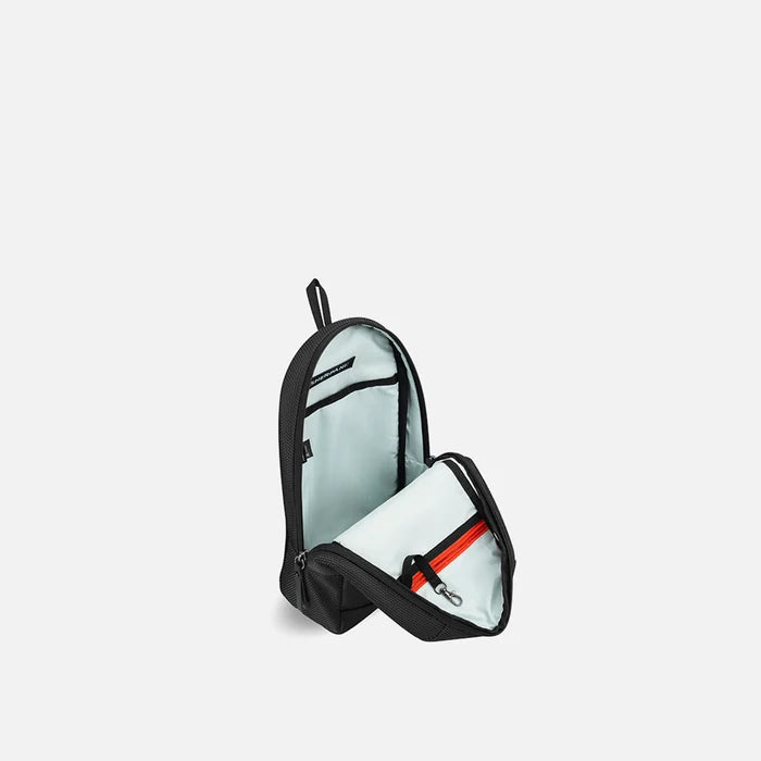 A Sherpani Metro Carbon Black Anti-theft Reversible Sling, 3/4 view open showing inside pocket against white background. #color_carbon-black
