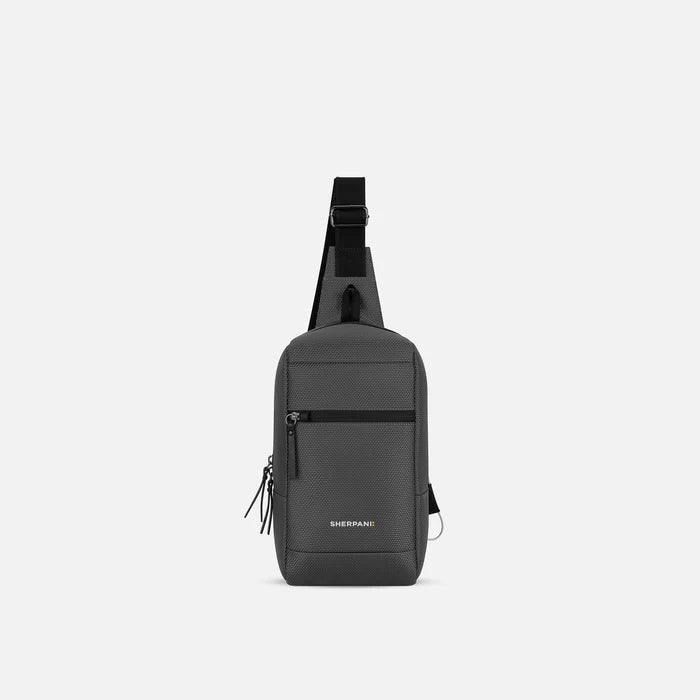 A Sherpani Metro Granite Anti-theft Reversible Sling, front view showing lockable pocket and main strap on white background. #color_granite-grey