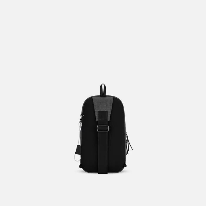 A Sherpani Metro Granite Anti-theft Reversible Sling, back view showing adjustable strap and chair lock on white background. #color_granite-grey