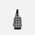 A Sherpani Metro Houndstooth Anti-theft Reversible Sling, front view showing lockable pocket and main strap on white background. #color_houndstooth-print
