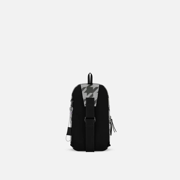 A Sherpani Metro Houndstooth Anti-theft Reversible Sling, back view showing adjustable strap and chair lock on white background. #color_houndstooth-print