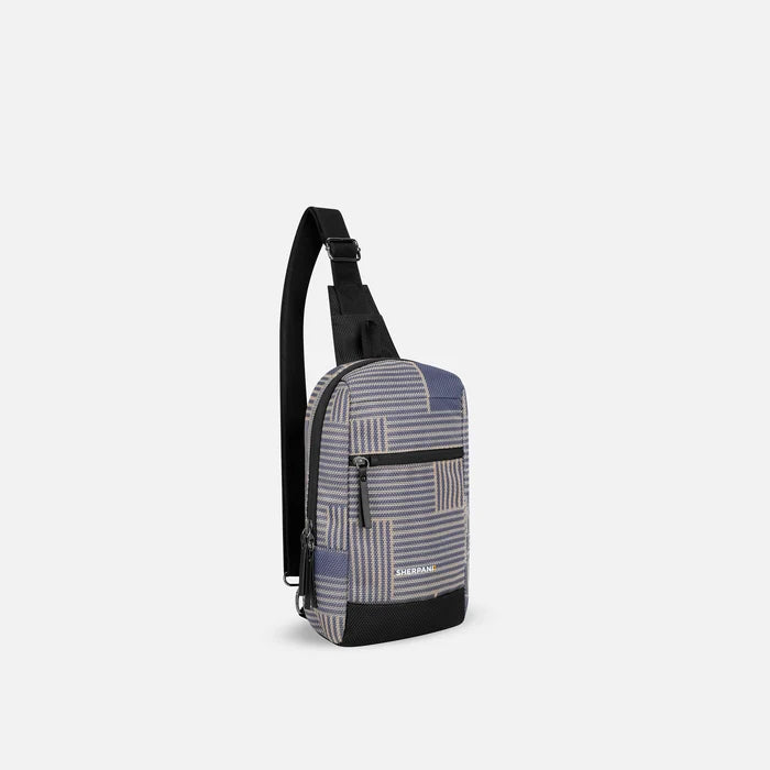 A Sherpani Metro Passport Anti-theft Reversible Sling, 3/4 view showing strap & lockable pocket on white background.  #color_passport-print