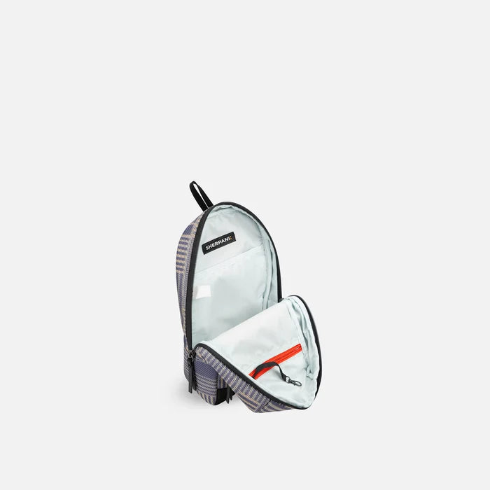 A Sherpani Metro Passport Anti-theft Reversible Sling, 3/4 view open showing inside pocket against white background. #color_passport-print