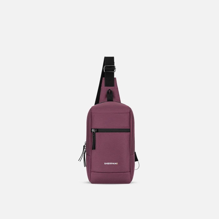A Sherpani Metro Smoky Orchid Anti-theft Reversible Sling, front view showing lockable pocket and main strap on white background. #color_smoky-orchid-pink