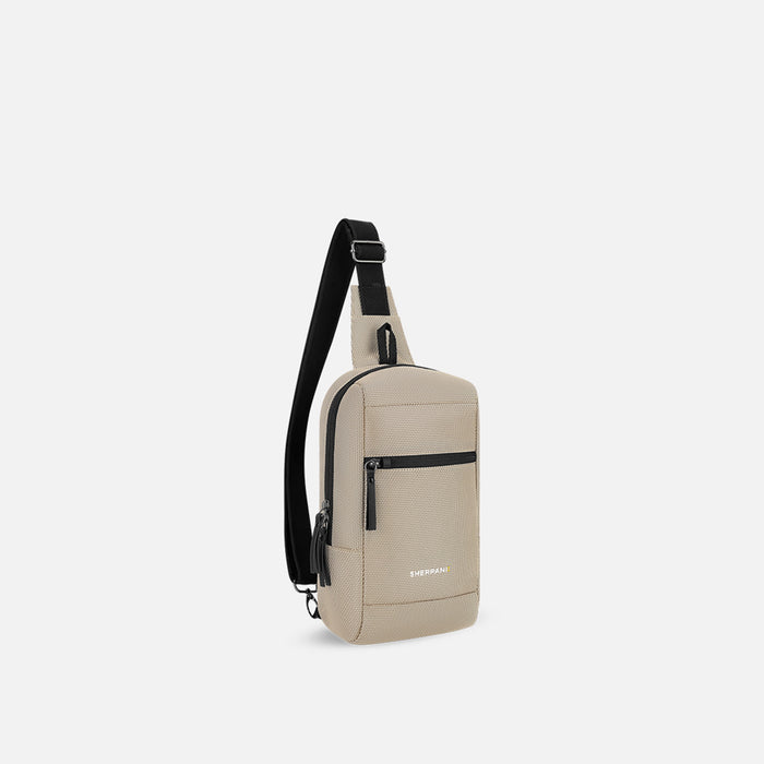 A Sherpani Metro Straw Beige Anti-theft Reversible Sling, 3/4 view showing strap & lockable pocket on white background. #color_straw-beige