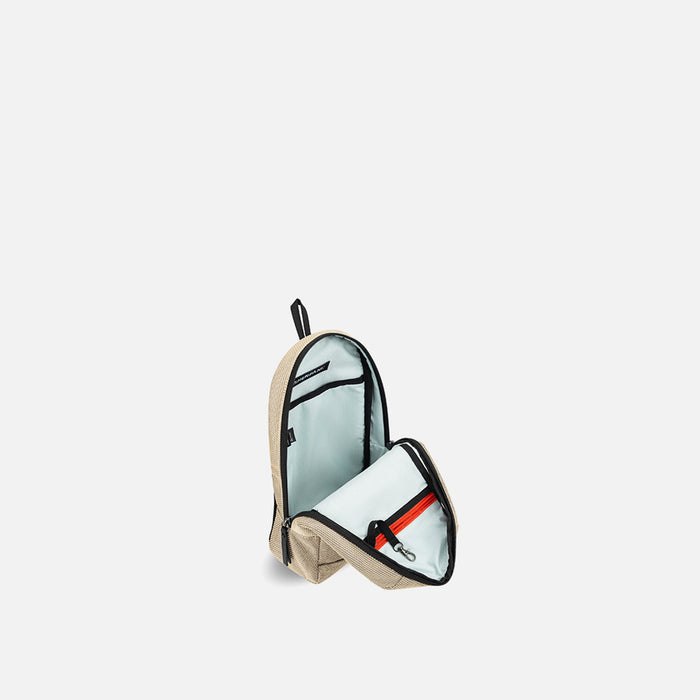 A Sherpani Metro Straw Beige Anti-theft Reversible Sling, 3/4 view open showing inside pocket against white background. #color_straw-beige