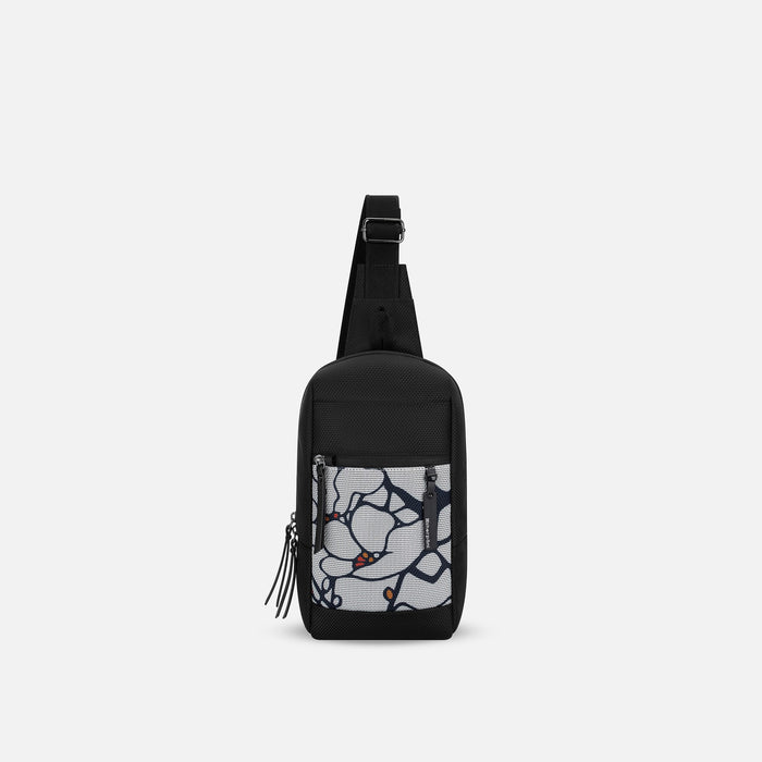 A Sherpani Metro Sakura Anti-theft Reversible Sling, front view showing strap & lockable pockets on white backdrop. #color_sakura-signature