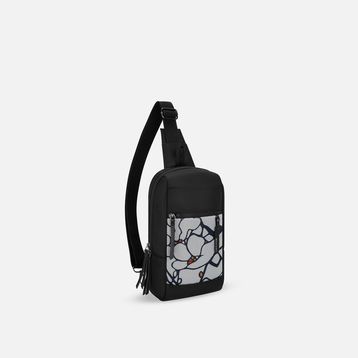 A Sherpani Metro Sakura Anti-theft Reversible Sling, 3/4 view showing strap & lockable pockets on white backdrop. #color_sakura-signature