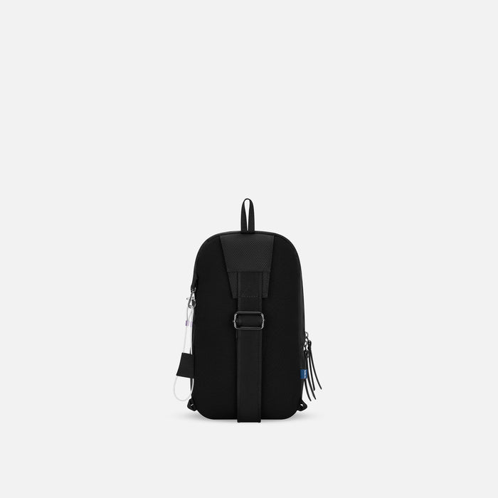 A Sherpani Metro Sakura Anti-theft Reversible Sling, back view showing adjustable strap on white backdrop. #color_sakura-signature