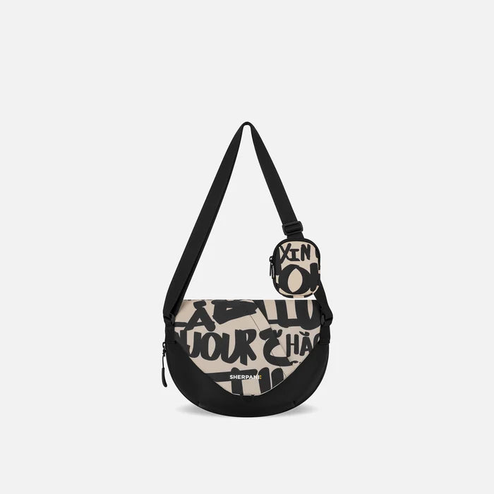 A Sherpani Milli Ciao Mini Messenger, front view showing lockable front zipper pocket against white background.  #color_ciao-print