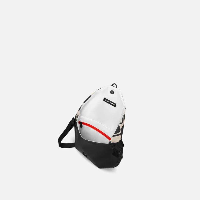 A Sherpani Milli Ciao Mini Messenger, above view showing inside main pocket against white backdrop.    #color_ciao-print