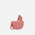 A Sherpani Milli Desert Pink Mini Messenger, front view showing lockable front zipper pocket against white background.  #color_desert-pink