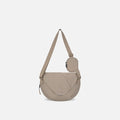 A Sherpani Milli Dune Mini Messenger, front view showing lockable front zipper pocket against white background.  #color_dune-tan