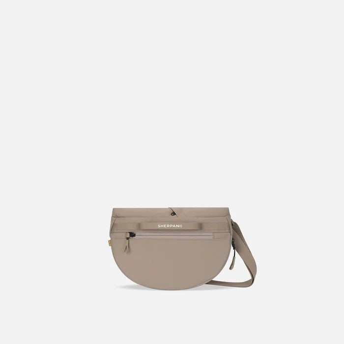 A Sherpani Milli Dune Mini Messenger, back view showing black backside. #color_dune-tan