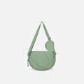 A Sherpani Milli Olivine Mini Messenger, front view showing lockable front zipper pocket against white background.  #color_olivine-green