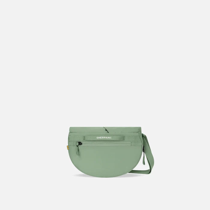A Sherpani Milli Olivine Mini Messenger, back view showing black backside. #color_olivine-green