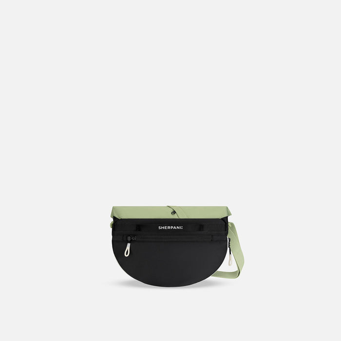 A Sherpani Milli Palm Green Mini Messenger, back view against white backdrop.  #color_palm-green