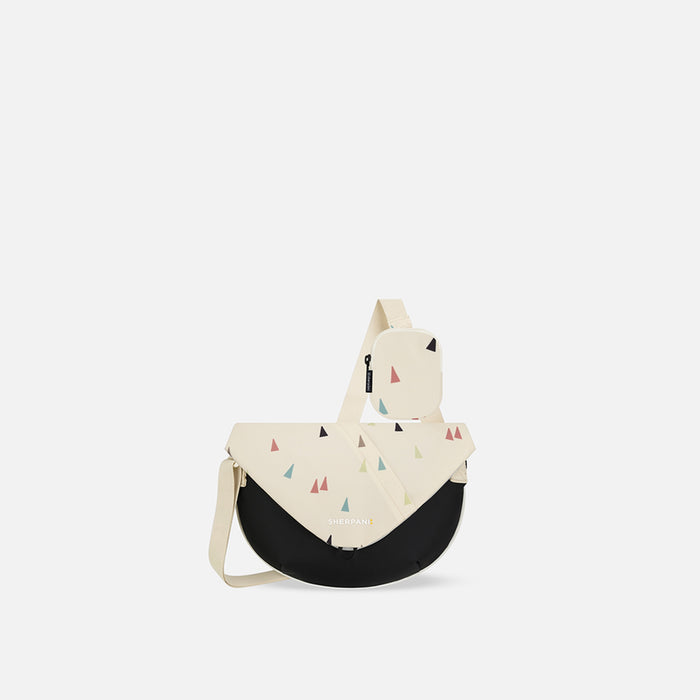 A Sherpani Milli Terrazzo Print Mini Messenger, front view showing lockable front zipper pocket against white background. #color_terrazzo-print