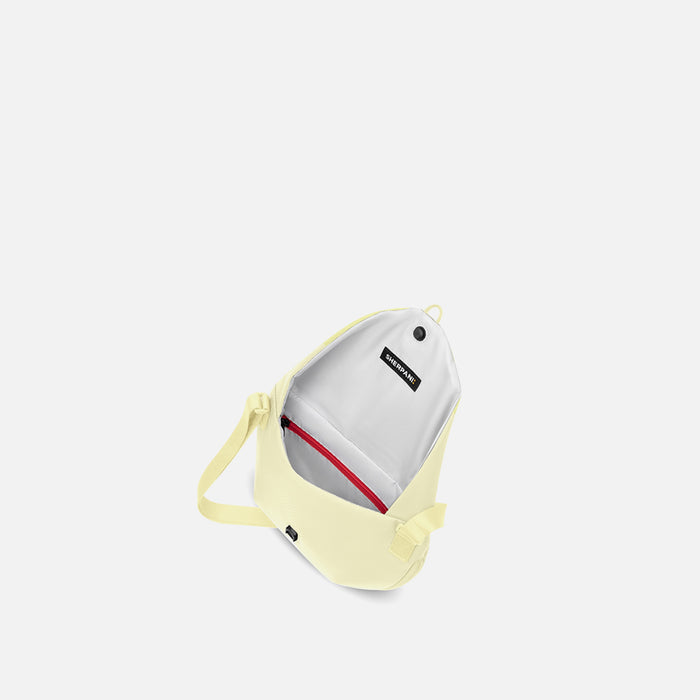 A Sherpani Milli Sol Yellow Mini Messenger, above view showing inside main pocket against white backdrop.    #color_sol-yellow