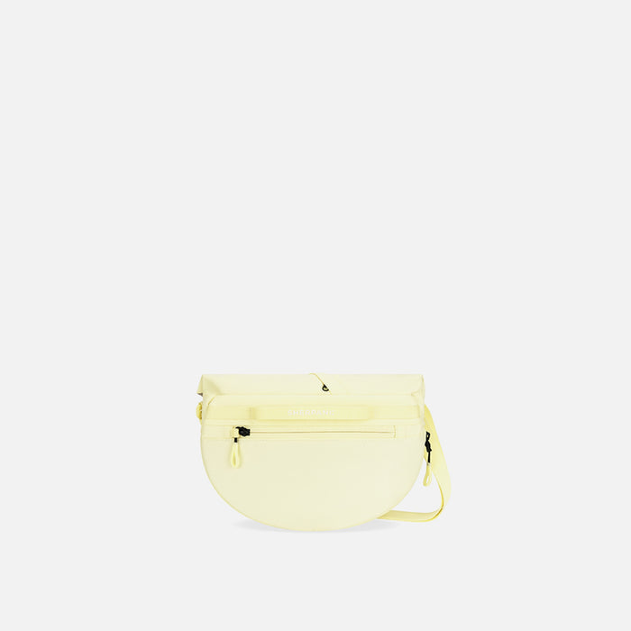 A Sherpani Milli Sol Yellow Mini Messenger, back view against white backdrop.  #color_sol-yellow