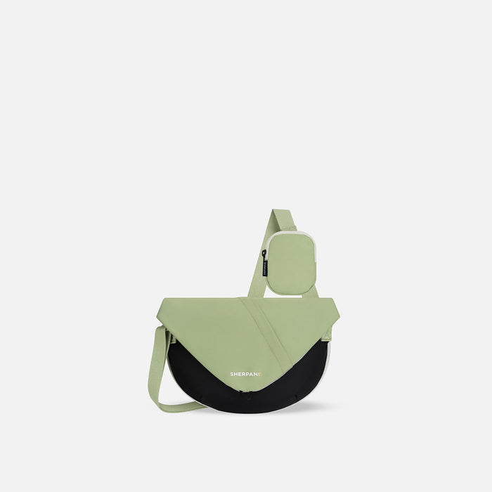 A Sherpani Milli Palm Green Mini Messenger, front view showing lockable front zipper pocket against white background.  #color_palm-green