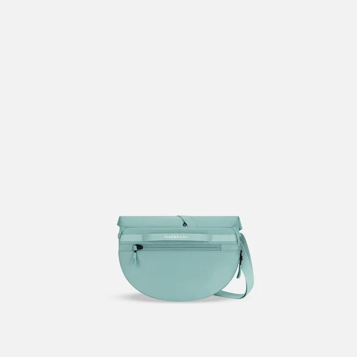 A Sherpani Milli Surf Blue Mini Messenger, back view showing black backside. #color_surf-blue