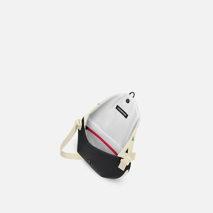 A Sherpani Milli Terrazzo Print Mini Messenger, above view showing inside main pocket against white backdrop.   #color_terrazzo-print