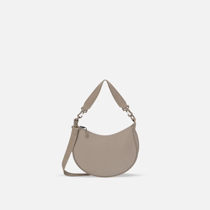 A Sherpani Mina Dune Medium Crossbody Bag, front view showing strap options on white background.  #color_dune-tan