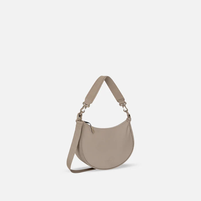 A Sherpani Mina Dune Medium Crossbody Bag, 3/4 view showing strap options on white background.  #color_dune-tan