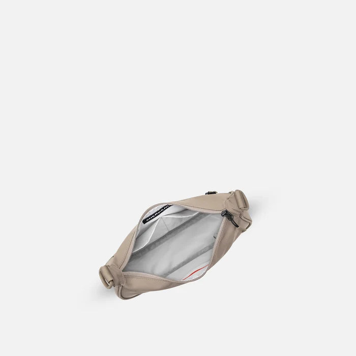 A Sherpani Mina Dune Medium Crossbody Bag, above view showing inside main pocket on white background.   #color_dune-tan