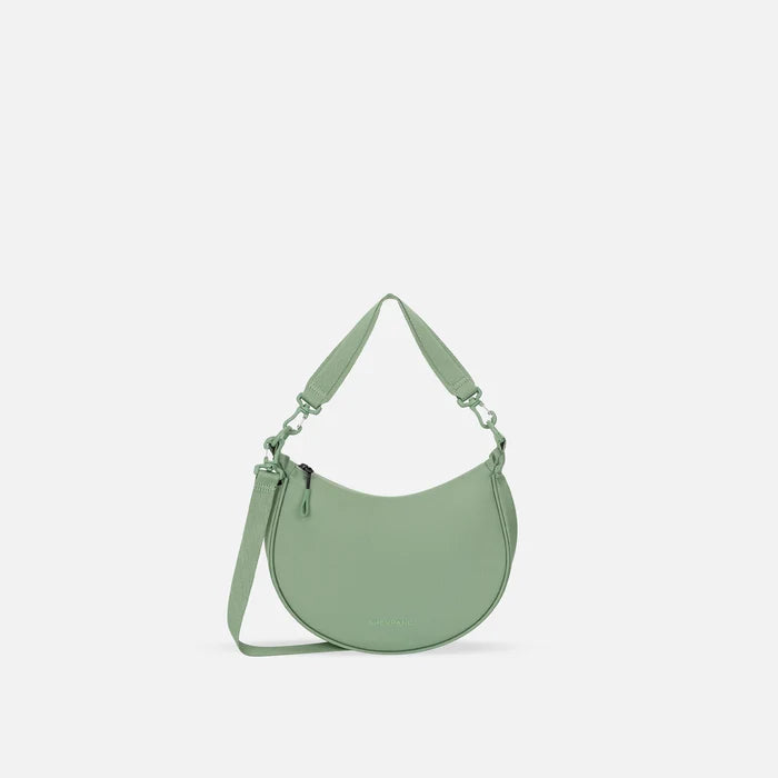 A Sherpani Mina Olivine Medium Crossbody Bag, front view showing strap options on white background.  #color_olivine-green