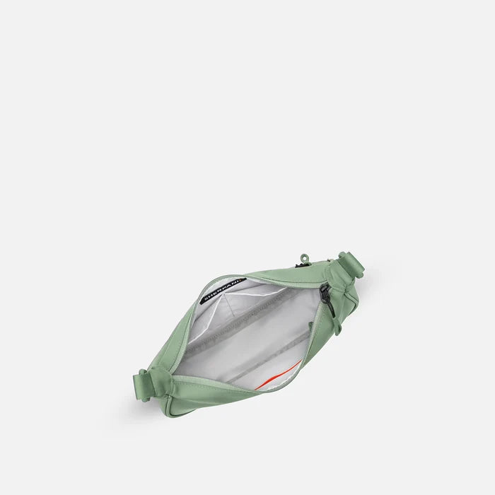 A Sherpani Mina Olivine Medium Crossbody Bag, above view showing inside main pocket on white background.   #color_olivine-green