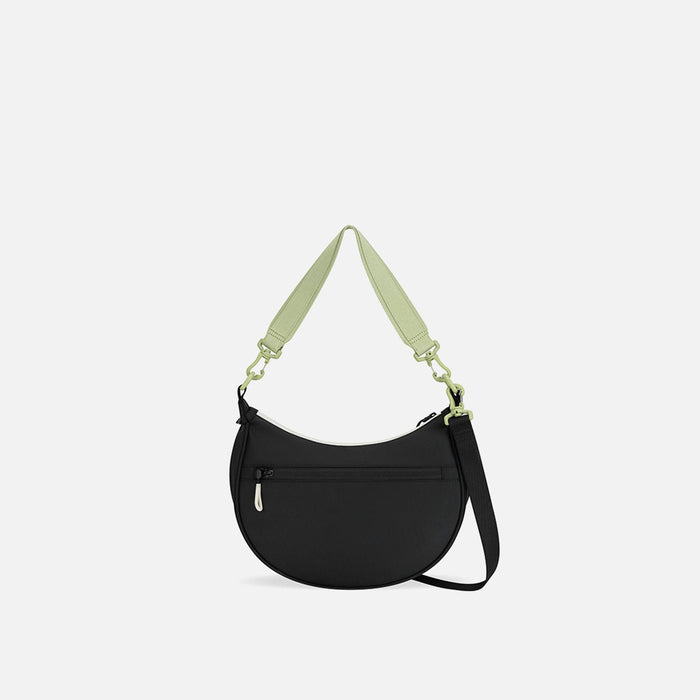 A Sherpani Mina Palm Green Medium Crossbody Bag, back view showing straps and lockable pocket on white background.  #color_palm-green