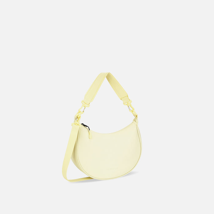 A Sherpani Mina Sol Yellow Medium Crossbody Bag, 3/4 view showing strap options on white background.  #color_sol-yellow