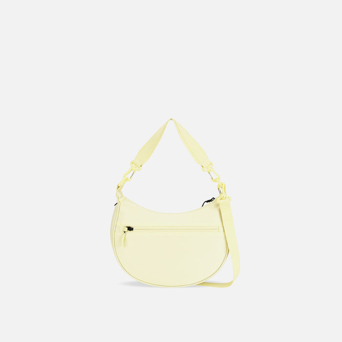 A Sherpani Mina Sol Yellow Medium Crossbody Bag, back view showing straps and lockable pocket on white background.  #color_sol-yellow