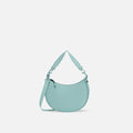 A Sherpani Mina Surf Blue Medium Crossbody Bag, front view showing strap options on white background.  #color_surf-blue