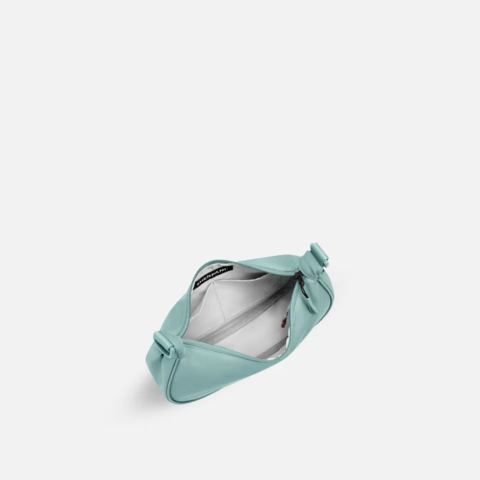 A Sherpani Mina Surf Blue  Medium Crossbody Bag, above view showing inside main pocket on white background.   #color_surf-blue