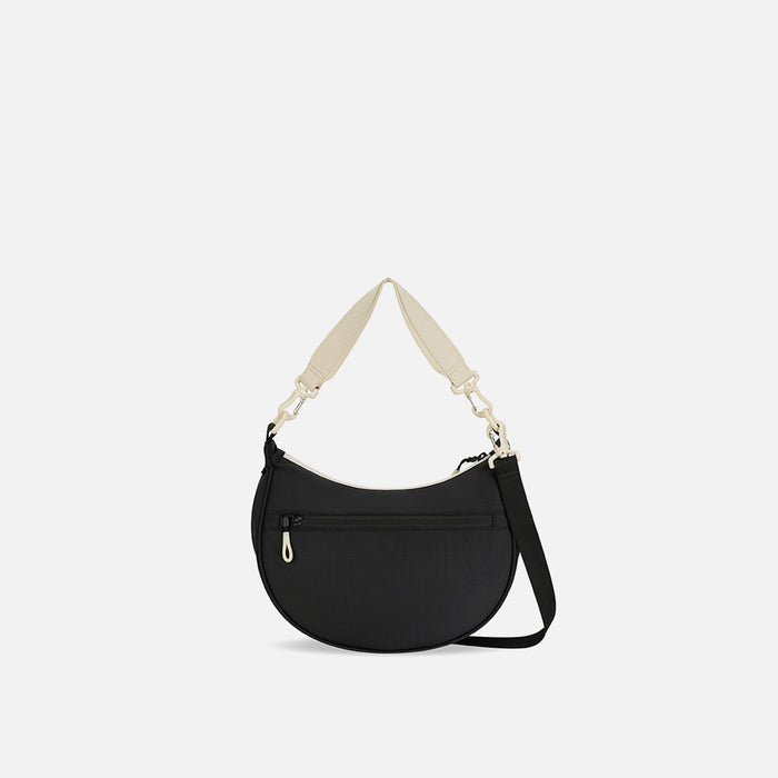 A Sherpani Mina Terrazzo Print Medium Crossbody Bag, back view showing straps and lockable pocket on white background.  #color_terrazzo-print